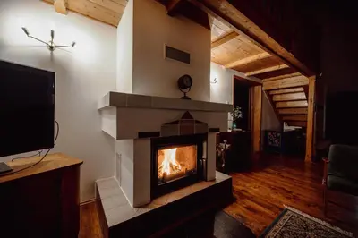 a fireplace in the middle of a living room at Willa Juszczyn in Juszczyn