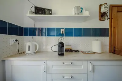 a kitchen with a counter top with blue tiles at Willa Juszczyn in Juszczyn