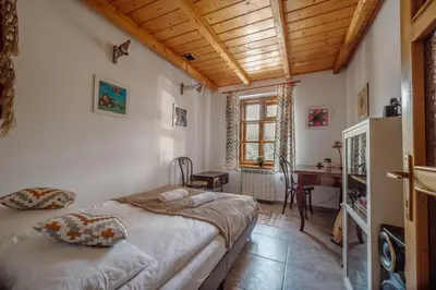 a bedroom with a bed and a desk in a room at Willa Juszczyn in Juszczyn