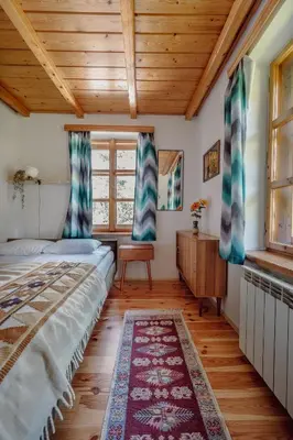 a bedroom with a bed and a wooden ceiling at Willa Juszczyn in Juszczyn
