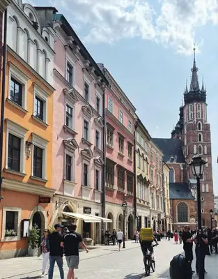 a group of people walking down a city street at Stylowy apartament w samym centrum Krakowa in Kraków