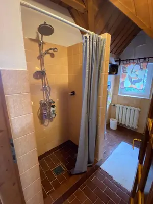 a bathroom with a shower with a shower curtain at Beskidzka Apartments in Sucha Beskidzka