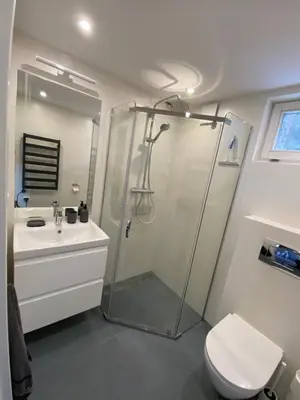 a bathroom with a shower and a toilet and a sink at Beskidzka Apartments in Sucha Beskidzka