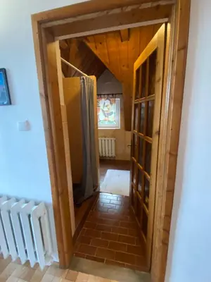 a hallway with a door leading into a room at Beskidzka Apartments in Sucha Beskidzka