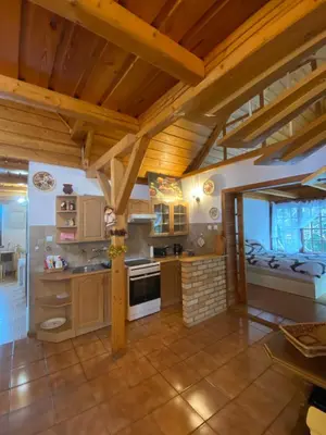 a large kitchen with wooden ceilings and wooden beams at Beskidzka Apartments in Sucha Beskidzka