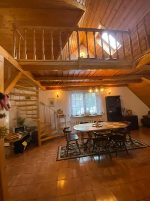 a dining room with a table and chairs in a room at Beskidzka Apartments in Sucha Beskidzka