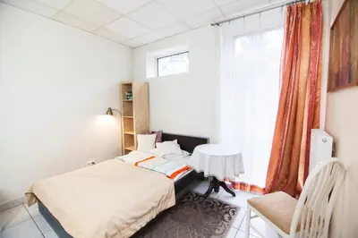 a bedroom with a bed and a window at Akacja Pokoje Gościnne in Kraków