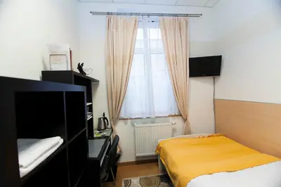 a bedroom with a bed and a window at Akacja Pokoje Gościnne in Kraków