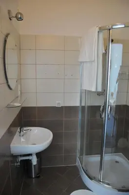 a bathroom with a sink and a shower and a toilet at Vinci in Kraków