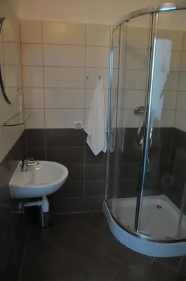 a bathroom with a shower and a sink at Vinci in Kraków