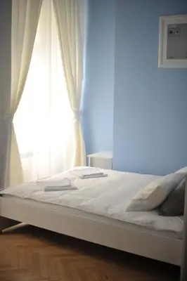 a bed in a room with a window at Vinci in Kraków