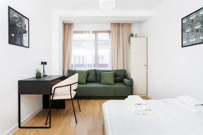 a living room with a green couch and a desk at Pretty 4 Bedroom Apartment in City Center - by Upstairs in Kraków