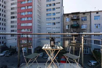 a view of a balcony with two chairs and buildings at Pretty 4 Bedroom Apartment in City Center - by Upstairs in Kraków