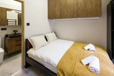 a bedroom with a bed with towels on it at Feel like home in Kraków in Kraków