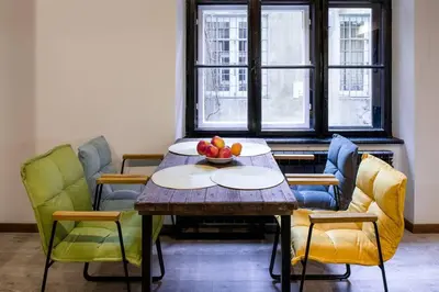 a table and chairs with a bowl of fruit on it at Feel like home in Kraków in Kraków