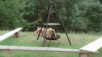 a swing in a field with a wooden bench at Noclegi i Agroturystyka Dorota Rusnak in Poręba Wielka