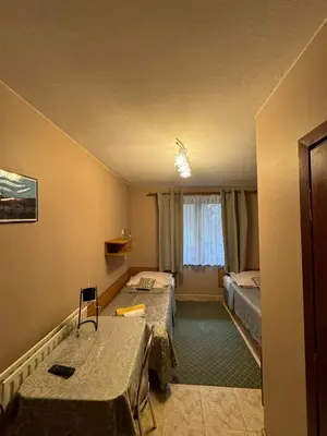 a bedroom with two beds and a window at Galant Hotel in Wieliczka
