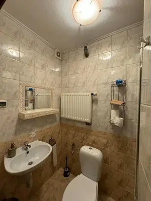a bathroom with a white toilet and a sink at Galant Hotel in Wieliczka