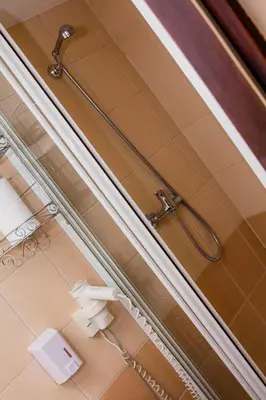 a bathroom with a sink and a mirror and a shower at Galant Hotel in Wieliczka