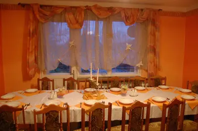 a dining room with a table with a white table cloth at Galant Hotel in Wieliczka