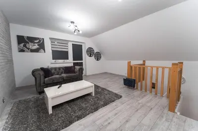 a living room with a couch and a coffee table at ŁOSOSINA 365 Dom z basenem in Łososina Dolna