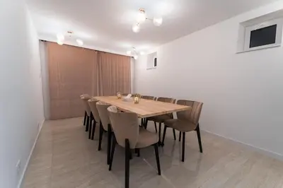 a dining room with a wooden table and chairs at ŁOSOSINA 365 Dom z basenem in Łososina Dolna