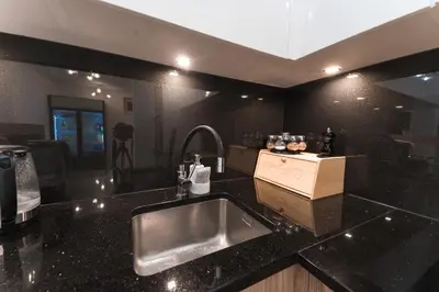 a kitchen with a sink and a counter top at ŁOSOSINA 365 Dom z basenem in Łososina Dolna