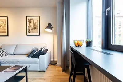 a living room with a couch and a table at Luxury standard apartment in Cracow in Kraków