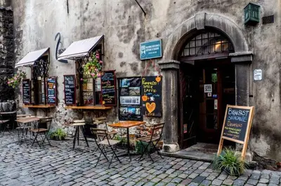 a restaurant with tables and chairs outside of a building at Luxury standard apartment in Cracow in Kraków