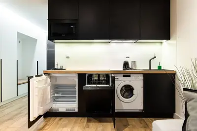 a kitchen with a washer and a washing machine at Luxury standard apartment in Cracow in Kraków