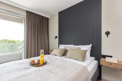 a bedroom with a large bed with a tray of food on it at River Side Residence 3/19 in Oświęcim