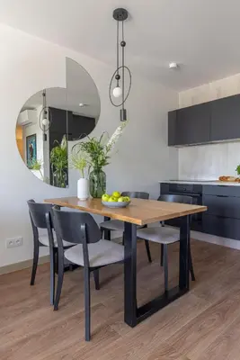 a kitchen with a wooden table and chairs at River Side Residence 3/19 in Oświęcim