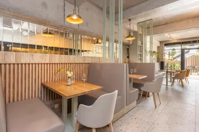a restaurant with wooden tables and chairs and tablesktop at River Side Residence 3/19 in Oświęcim