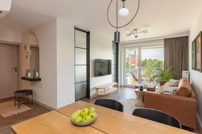 a living room and dining room with a dining table at River Side Residence 3/19 in Oświęcim