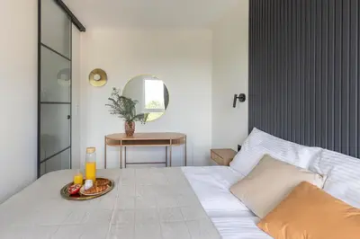 a bedroom with a bed with a tray of food on it at River Side Residence 3/19 in Oświęcim