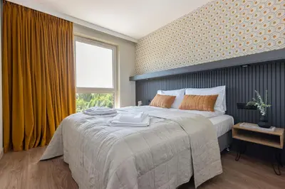 a bedroom with a large bed and a window at River Side Residence 3/18 in Oświęcim