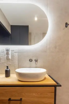 a bathroom with a white sink and a mirror at River Side Residence 3/18 in Oświęcim