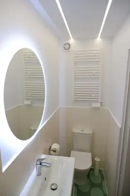 a bathroom with a sink and a toilet with a mirror at Czas i Las Glamping in Sadek