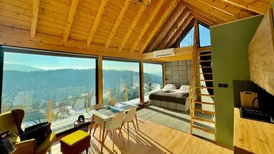 a room with a bed and a room with a view at Czas i Las Glamping in Sadek