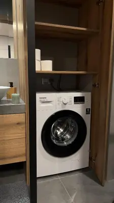 a washer and dryer sitting in a kitchen at Parkcity Kraków in Kraków