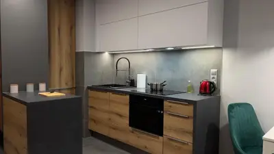 a kitchen with a sink and a stove top oven at Parkcity Kraków in Kraków
