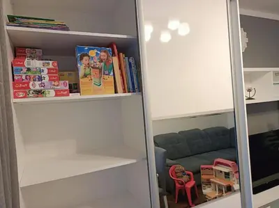 a book shelf filled with books and a couch at Apartament u Oli i Laury in Kraków