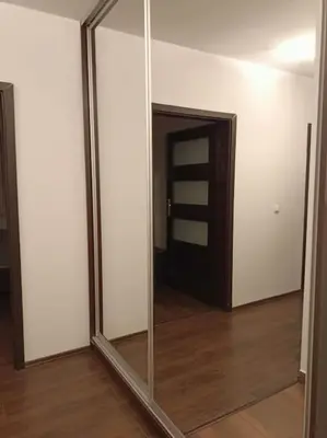 a large mirror in a room with a door at Apartament u Oli i Laury in Kraków