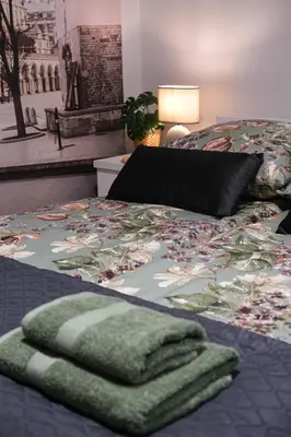 a bedroom with a bed with a blanket on it at Old Town WAWEL II Premium Apartments in Kraków