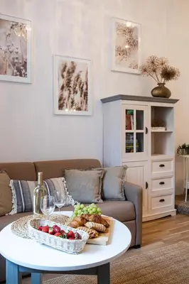 a living room with a table with a bowl of fruit at Old Town WAWEL II Premium Apartments in Kraków