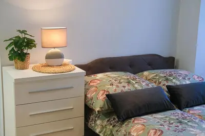 a bedroom with a bed and a lamp on a dresser at Old Town WAWEL II Premium Apartments in Kraków