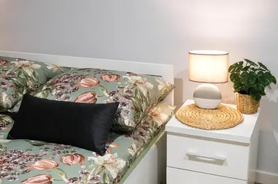 a couch with a pillow and a lamp on a nightstand at Old Town WAWEL II Premium Apartments in Kraków
