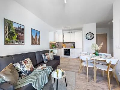 a living room with a couch and a table at Nowoczesny Apartament w okolicy Tauron Areny in Kraków