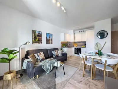 a living room with a couch and a table at Nowoczesny Apartament w okolicy Tauron Areny in Kraków