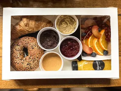 a white box filled with different types of food at Tyzenhauz Suites Topolowa in Kraków